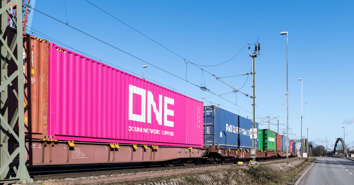 Colorful freight train containers passing through a rail line in Hamburg, Germany.